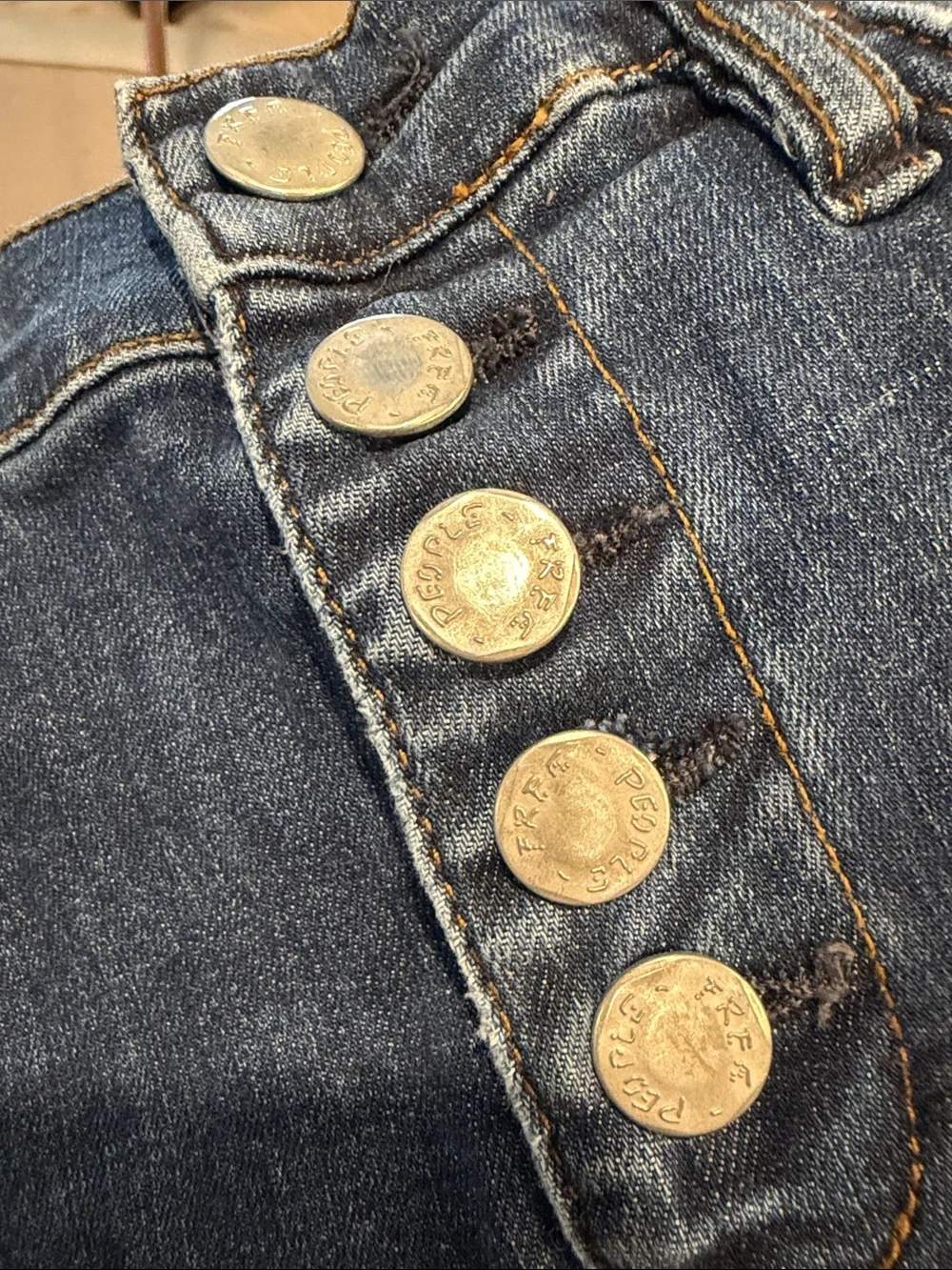 Free People indigo denim jeans with gold stitching